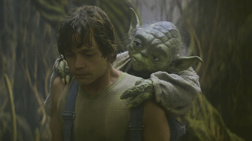 Yoda putting Luke Skywalker through training